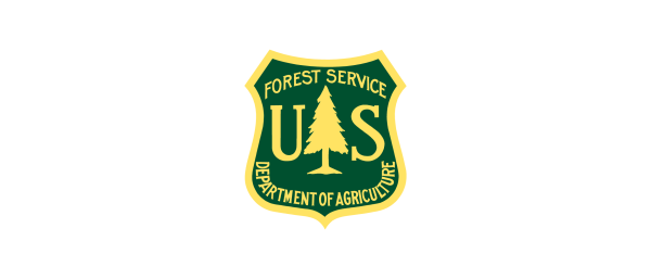 The image features a shield-shaped emblem with a green background. It includes the text "FOREST SERVICE" at the top, "U.S." in the center, and "DEPARTMENT OF AGRICULTURE" at the bottom. A stylized tree is depicted in the center of the emblem
