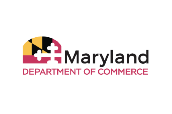 The logo features the words "Maryland Department of Commerce" in bold text. Above the text is a graphic that includes the Maryland state flag's colors and patterns, incorporating a yellow and black design with a white cross. The overall design is modern and professional