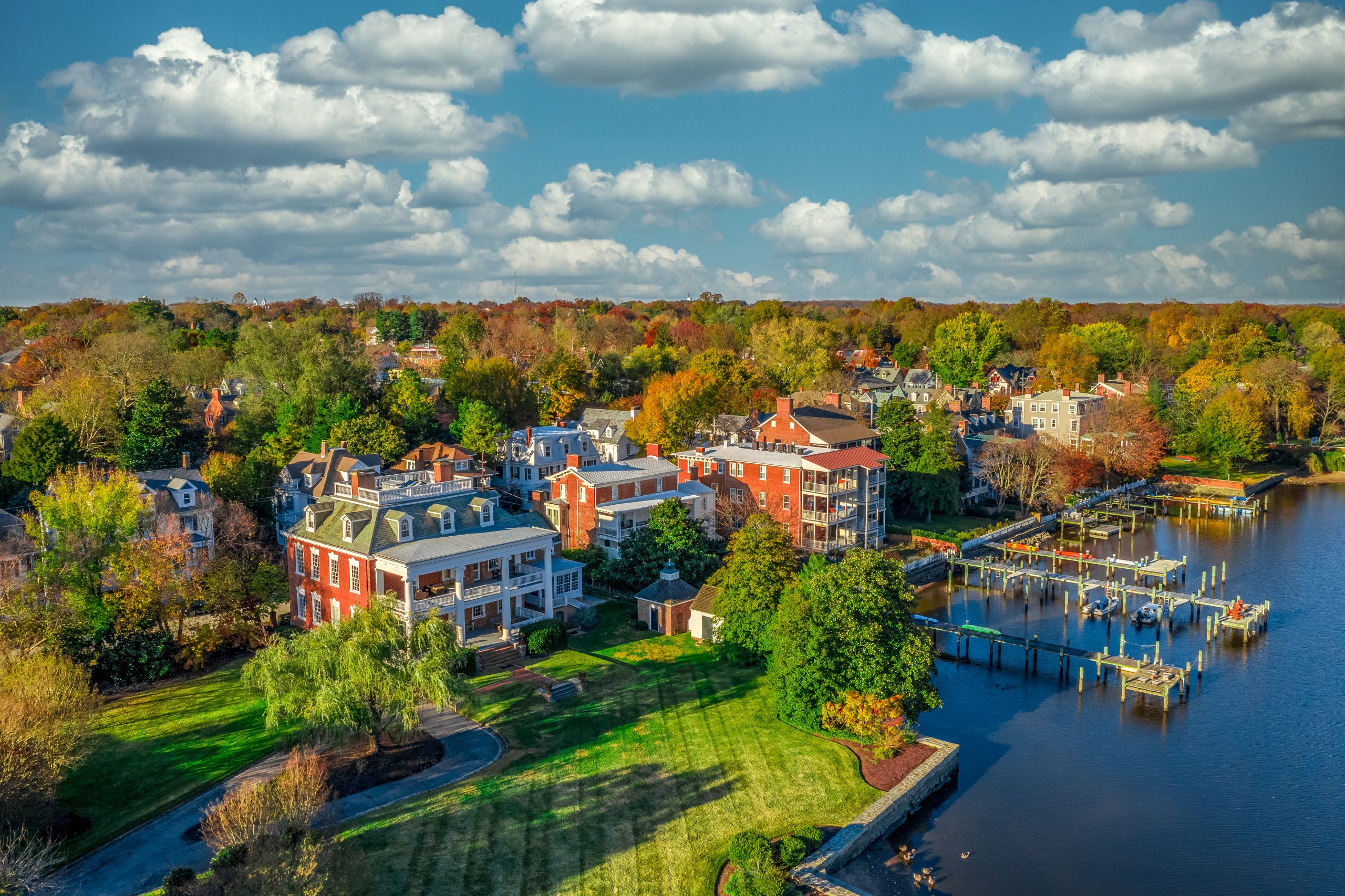 Aerial view of a waterfront area featuring a mix of residential buildings and docks.