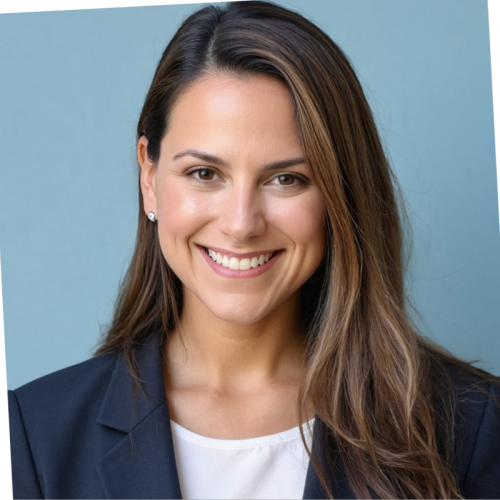 A woman with long, brown hair smiles at the camera, wearing a black blazer over a white top. The background is a light blue color